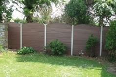 Walnut gravel boards fitted into existing concrete posts.